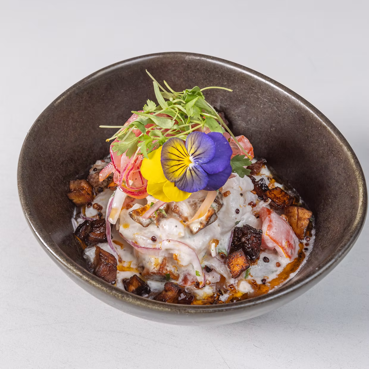 Ceviche Carnavalero with plantain, quinoa and edible flowers